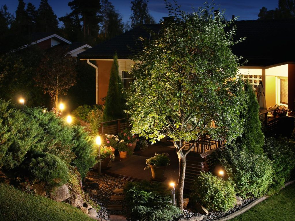 Front yard landscaping in Olathe, KS with rock edging and perennials